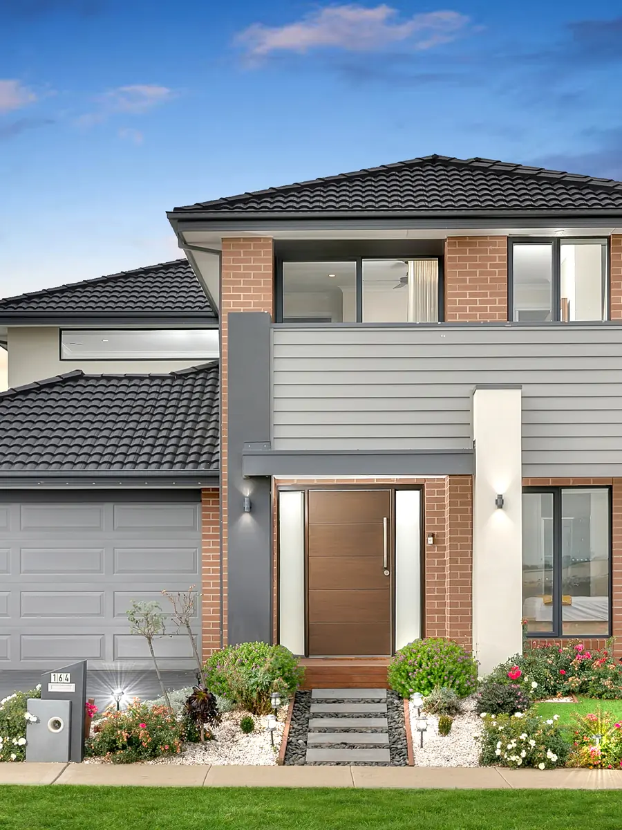 Two-storey Melbourne home at dusk with a pink sky &mdash; twilight real estate photography Melbourne
