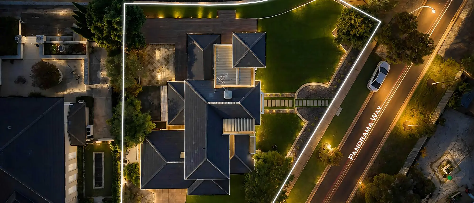 Night aerial photograph of a Melbourne property, streetlights tracing the block below