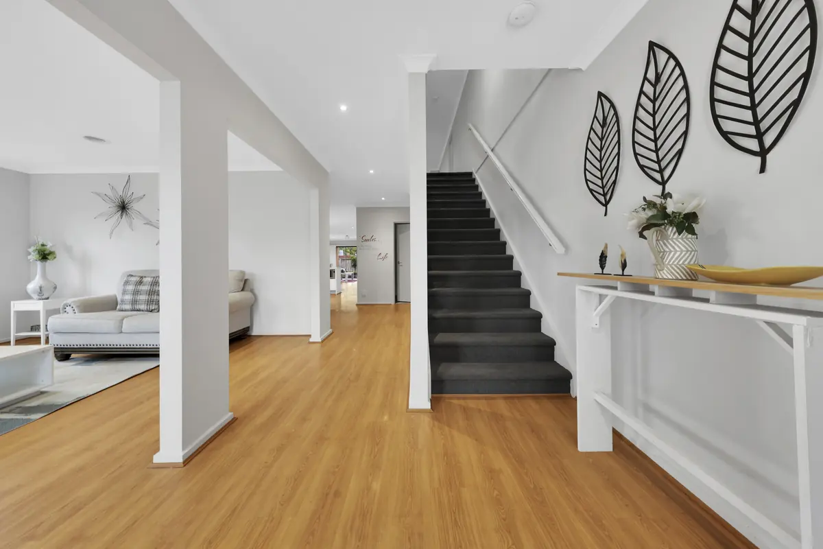 Oak-tread staircase in a bright hallway &mdash; real estate photography Melbourne